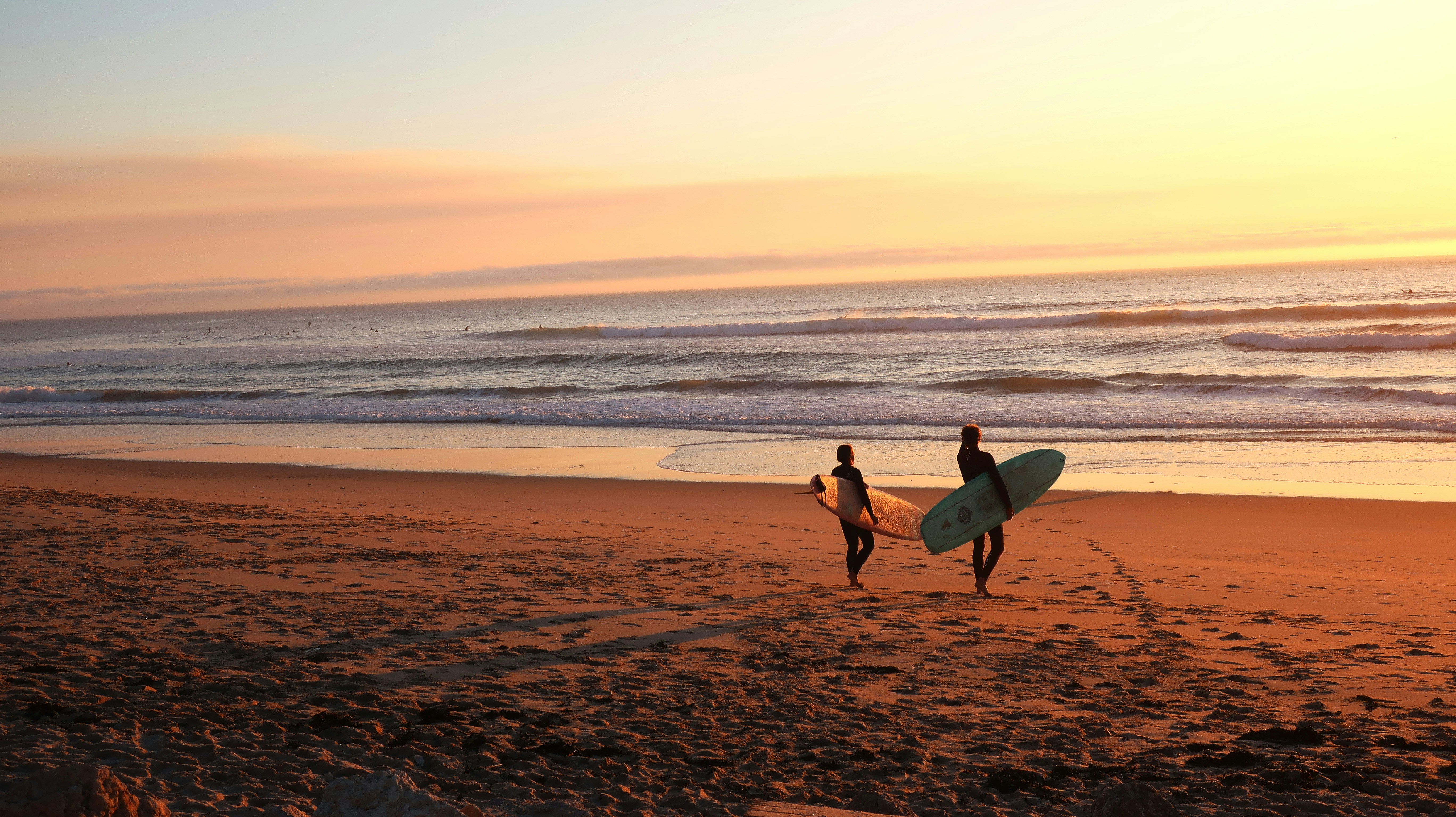 Surfer catching a wave at sunset